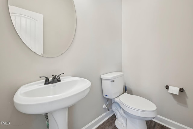 265 Wind Swept St, Raeford, NC 28376 - bathroom with toilet, baseboards, wood finished floors, and a sink