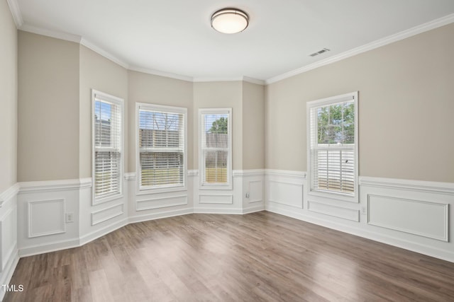 265 Wind Swept St, Raeford, NC 28376 - empty room featuring wood finished floors, a wainscoted wall, and ornamental molding