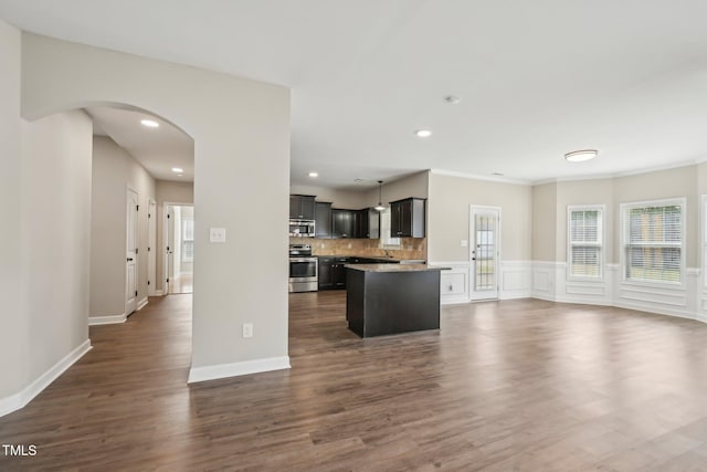 265 Wind Swept St, Raeford, NC 28376 - kitchen with appliances with stainless steel finishes, open floor plan, plenty of natural light, arched walkways, and recessed lighting