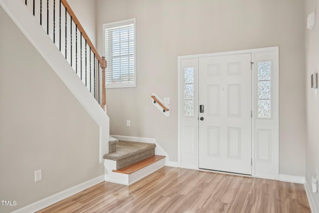 265 Wind Swept St, Raeford, NC 28376 - foyer featuring healthy amount of natural light, wood finished floors, stairs, and a high ceiling