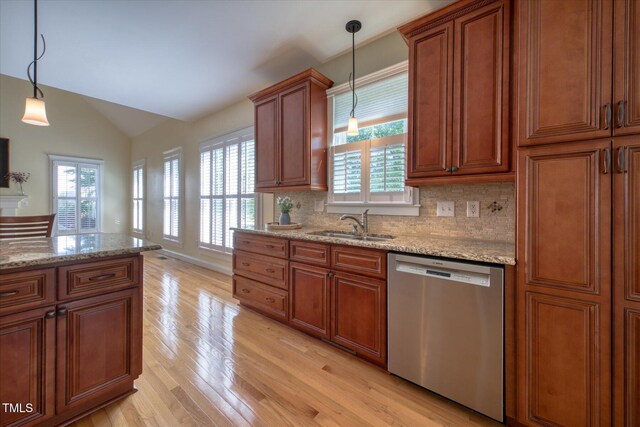kitchen featuring dishwasher, light wood-style floors, vaulted ceiling, a sink, and brown cabinets