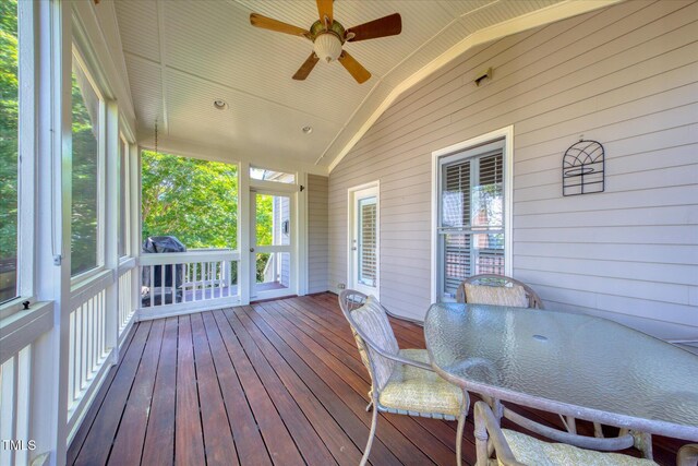 wooden terrace featuring a ceiling fan and outdoor dining area