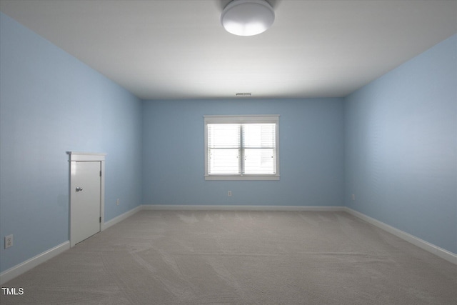 empty room with light carpet and baseboards