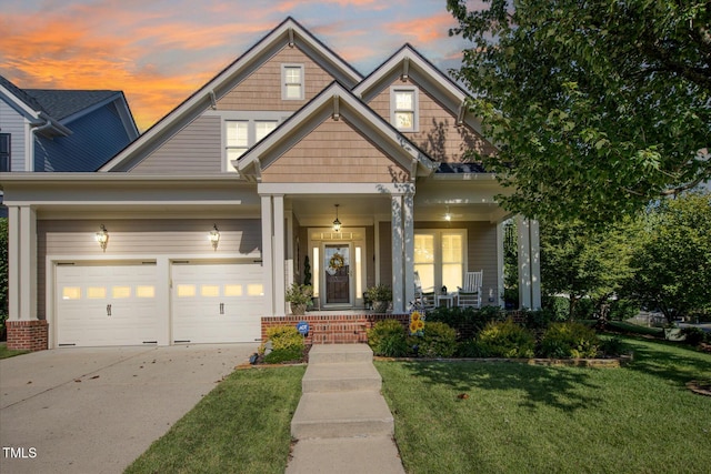 craftsman-style house featuring a front yard, concrete driveway, a porch, and an attached garage