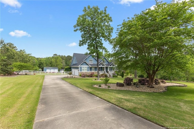 view of front of house with fence and a front lawn
