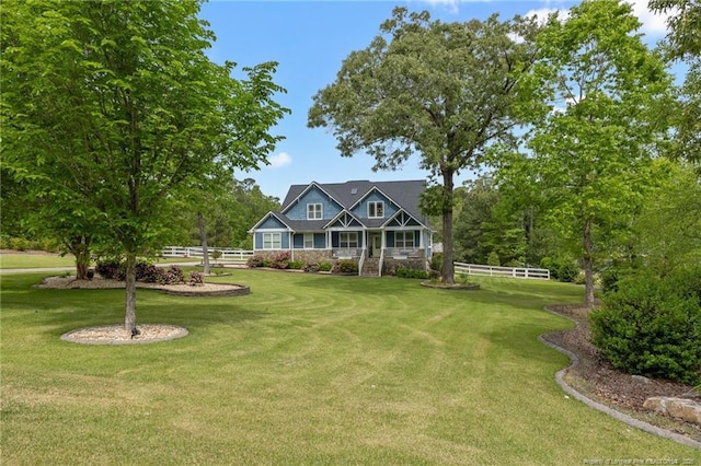 view of front of home with a front lawn and fence