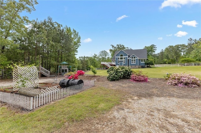 view of yard featuring fence and a deck