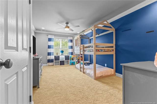 bedroom with carpet flooring, crown molding, baseboards, and a ceiling fan