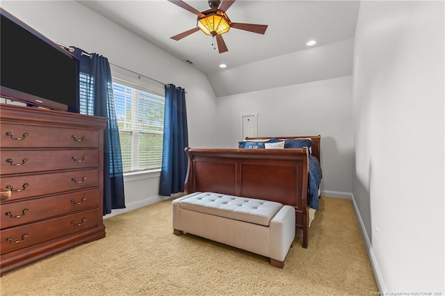 bedroom with light colored carpet, vaulted ceiling, and baseboards