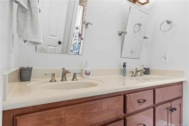 full bathroom with a sink and double vanity
