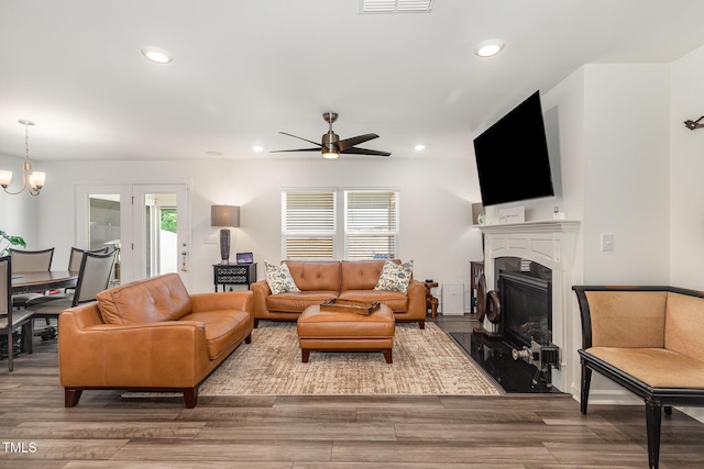 1012 Ringhill Bluff Dr, Durham, NC 27704 - living area featuring healthy amount of natural light, ceiling fan, a glass covered fireplace, wood finished floors, and recessed lighting
