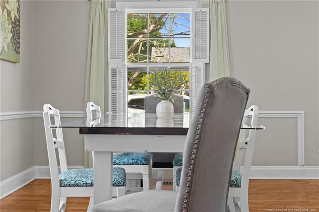 dining room with wood finished floors and baseboards