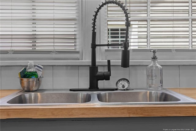 interior details featuring tasteful backsplash and a sink