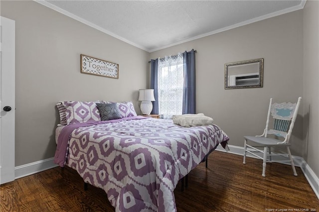 bedroom featuring crown molding, a textured ceiling, baseboards, and wood finished floors