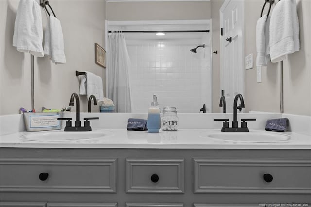full bathroom with a sink, double vanity, and a shower with shower curtain