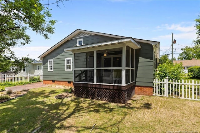 rear view of house featuring a sunroom