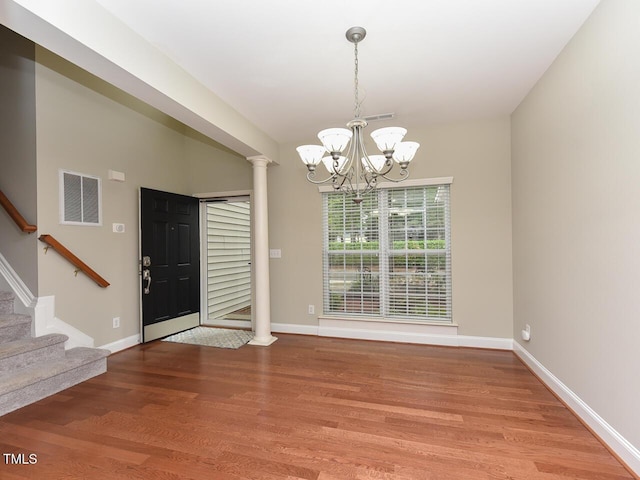 3339 Archdale Dr, Raleigh, NC 27614 - entrance foyer featuring wood finished floors, decorative columns, stairs, and a chandelier