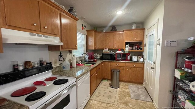3412 Seven Mountain Dr, Fayetteville, NC 28306 - kitchen with white appliances, under cabinet range hood, a sink, a textured ceiling, and brown cabinets