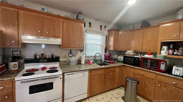 3412 Seven Mountain Dr, Fayetteville, NC 28306 - kitchen featuring under cabinet range hood, white appliances, a sink, brown cabinets, and a textured ceiling