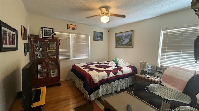 3412 Seven Mountain Dr, Fayetteville, NC 28306 - bedroom featuring wood finished floors, a textured ceiling, and ceiling fan