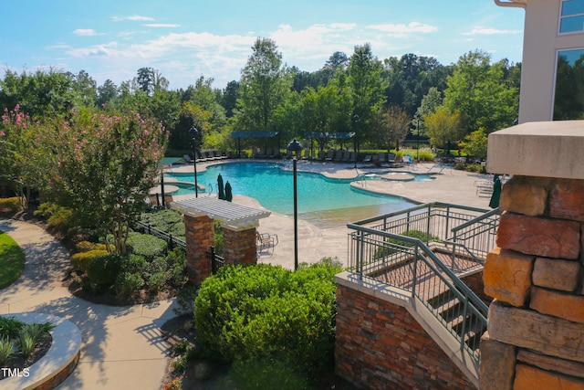 community pool with a patio and a pergola
