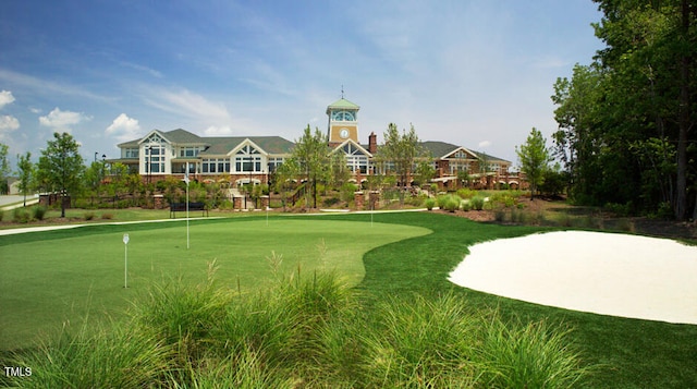 view of home's community featuring a putting green