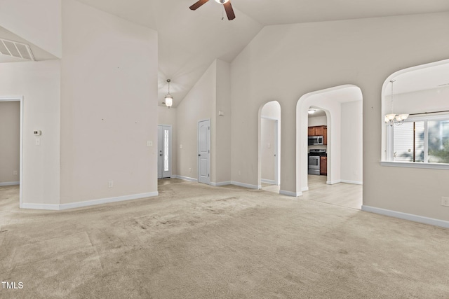 309 Coachmans Trl, Stem, NC 27581 - unfurnished living room featuring ceiling fan, carpet floors, high vaulted ceiling, arched walkways, and baseboards