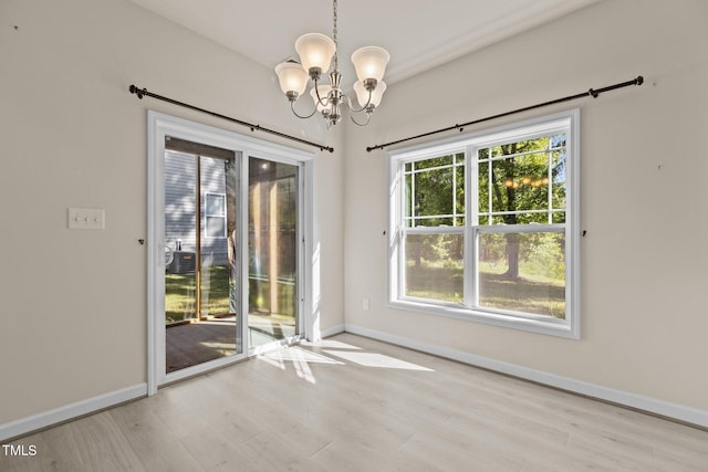 309 Coachmans Trl, Stem, NC 27581 - unfurnished dining area featuring a chandelier, wood finished floors, and baseboards