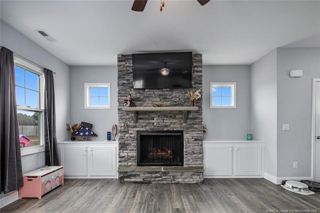 living room featuring a ceiling fan, wood finished floors, and plenty of natural light