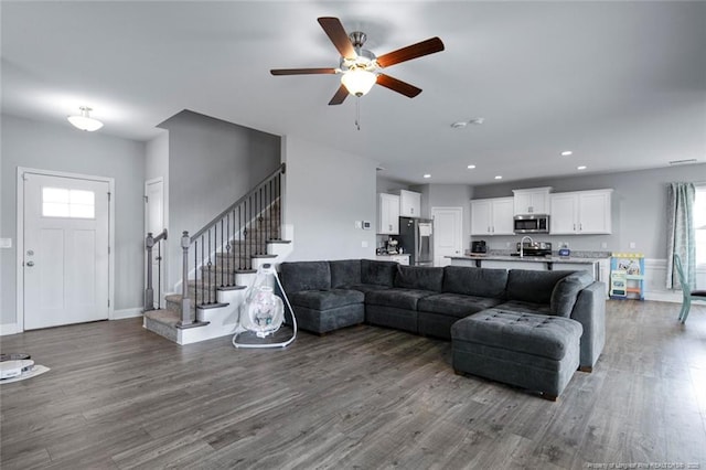 living room featuring stairway, wood finished floors, ceiling fan, recessed lighting, and baseboards