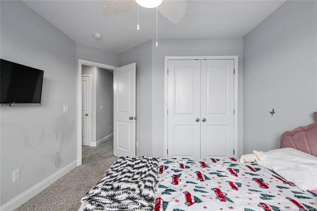 carpeted bedroom with baseboards, a closet, and ceiling fan