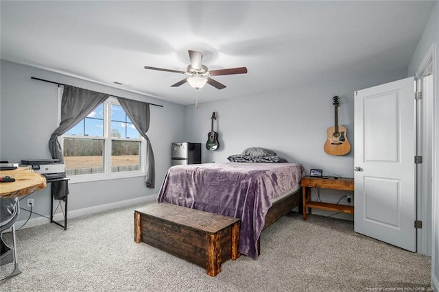carpeted bedroom featuring baseboards and ceiling fan