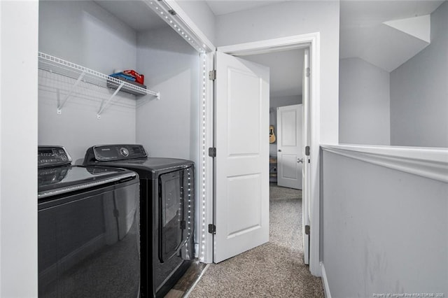 laundry area featuring washing machine and dryer and dark colored carpet