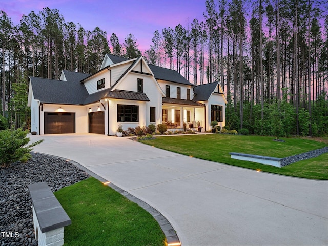 604 Dappled Pine Ave, Durham, NC 27713 - modern inspired farmhouse with a standing seam roof, driveway, a yard, metal roof, and an attached garage