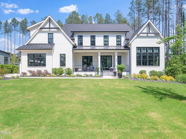 604 Dappled Pine Ave, Durham, NC 27713 - modern farmhouse with a standing seam roof, covered porch, and a front lawn