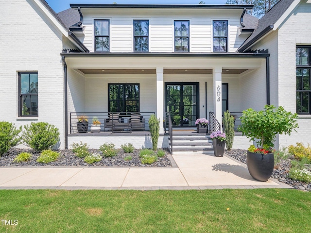 604 Dappled Pine Ave, Durham, NC 27713 - view of front facade featuring brick siding and covered porch