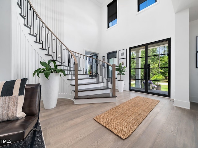604 Dappled Pine Ave, Durham, NC 27713 - foyer entrance featuring a high ceiling, stairway, wood finished floors, and baseboards