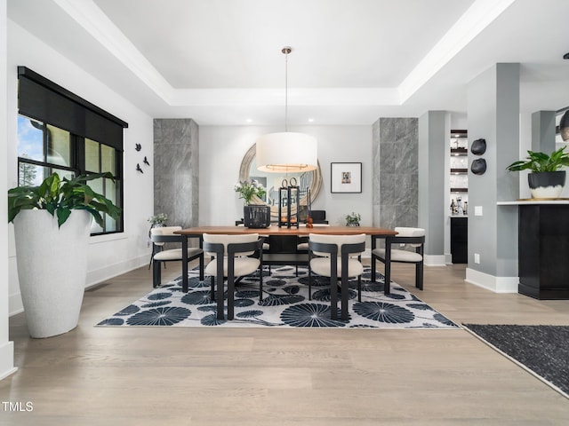 604 Dappled Pine Ave, Durham, NC 27713 - dining area with a raised ceiling, wood finished floors, and baseboards
