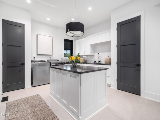 604 Dappled Pine Ave, Durham, NC 27713 - kitchen featuring washer and dryer, a sink, dark countertops, white cabinetry, and recessed lighting