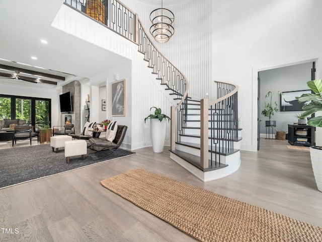 604 Dappled Pine Ave, Durham, NC 27713 - stairway featuring a high ceiling, wood finished floors, baseboards, and recessed lighting