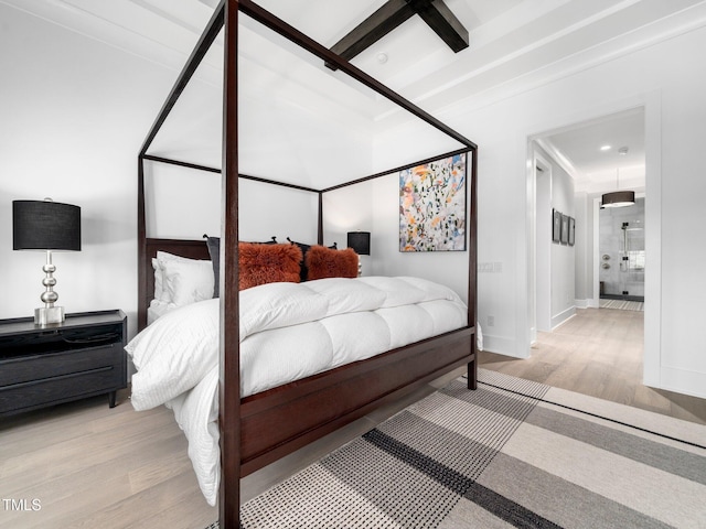 604 Dappled Pine Ave, Durham, NC 27713 - bedroom featuring wood finished floors, baseboards, and connected bathroom