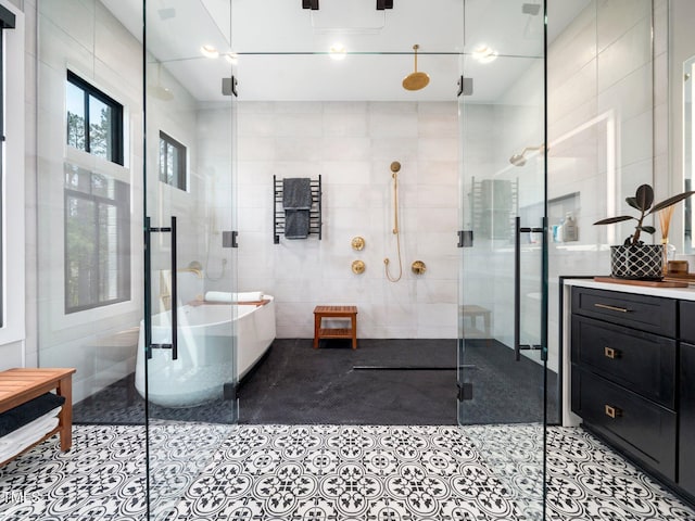 604 Dappled Pine Ave, Durham, NC 27713 - full bath featuring tile walls, a stall shower, tile patterned floors, a soaking tub, and vanity