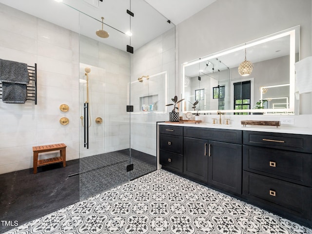604 Dappled Pine Ave, Durham, NC 27713 - bathroom featuring tiled shower, vanity, a towel warming rack, and tile walls