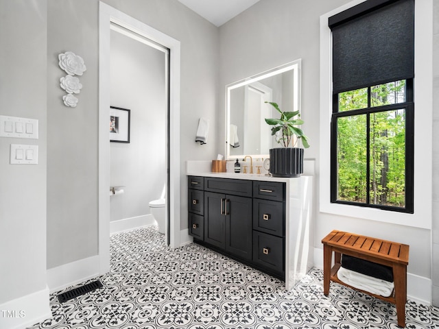 604 Dappled Pine Ave, Durham, NC 27713 - bathroom featuring vanity, toilet, and baseboards