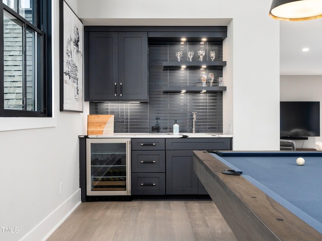 604 Dappled Pine Ave, Durham, NC 27713 - indoor wet bar with wine cooler, tasteful backsplash, light wood-type flooring, and baseboards