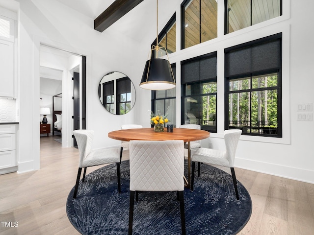 604 Dappled Pine Ave, Durham, NC 27713 - dining room with baseboards, light wood-type flooring, beamed ceiling, and a high ceiling