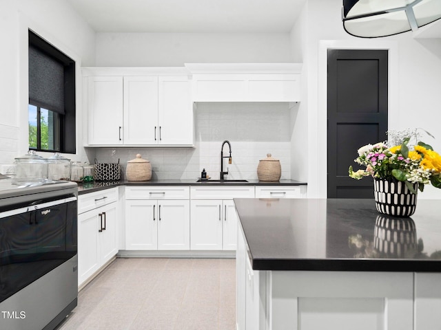 604 Dappled Pine Ave, Durham, NC 27713 - kitchen featuring a sink, range, dark countertops, and backsplash