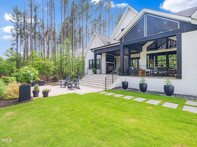 604 Dappled Pine Ave, Durham, NC 27713 - back of house with a sunroom, a patio, a lawn, and stairway