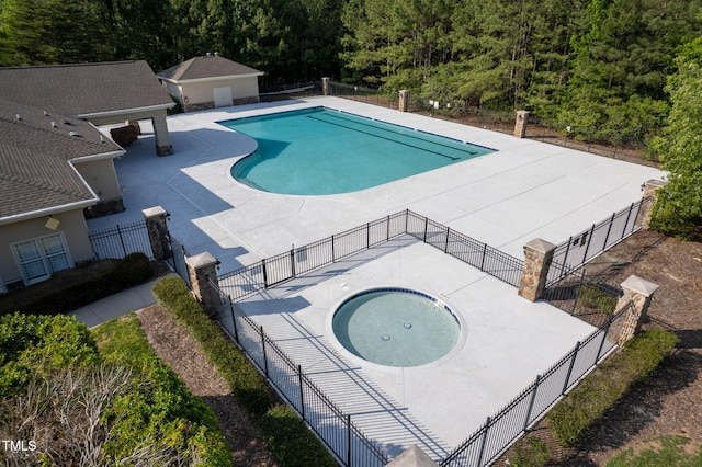 604 Dappled Pine Ave, Durham, NC 27713 - community pool with a community hot tub, a patio area, and a view of trees