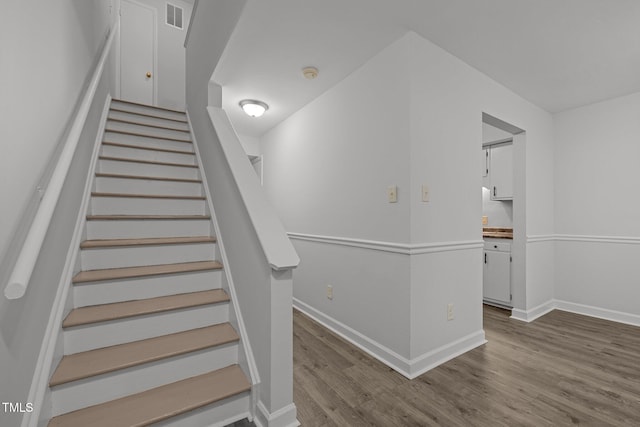 1131 Schaub Dr, Raleigh, NC 27606 - stairway with wood finished floors and baseboards